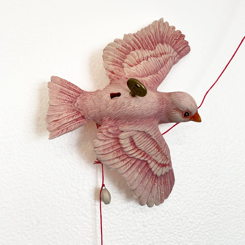 Ceramic pink canary with key and keyhole