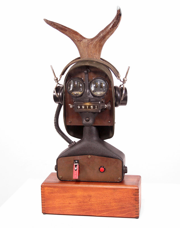 sculpture character composed of lenses and other repurposed components