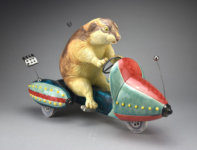 Ceramic sculpture of a lemming on a space scooter.