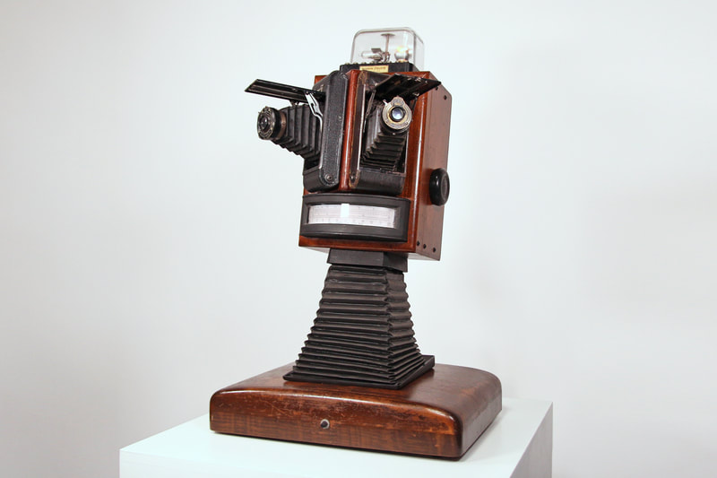 sculpture character composed of dials and other repurposed camera components