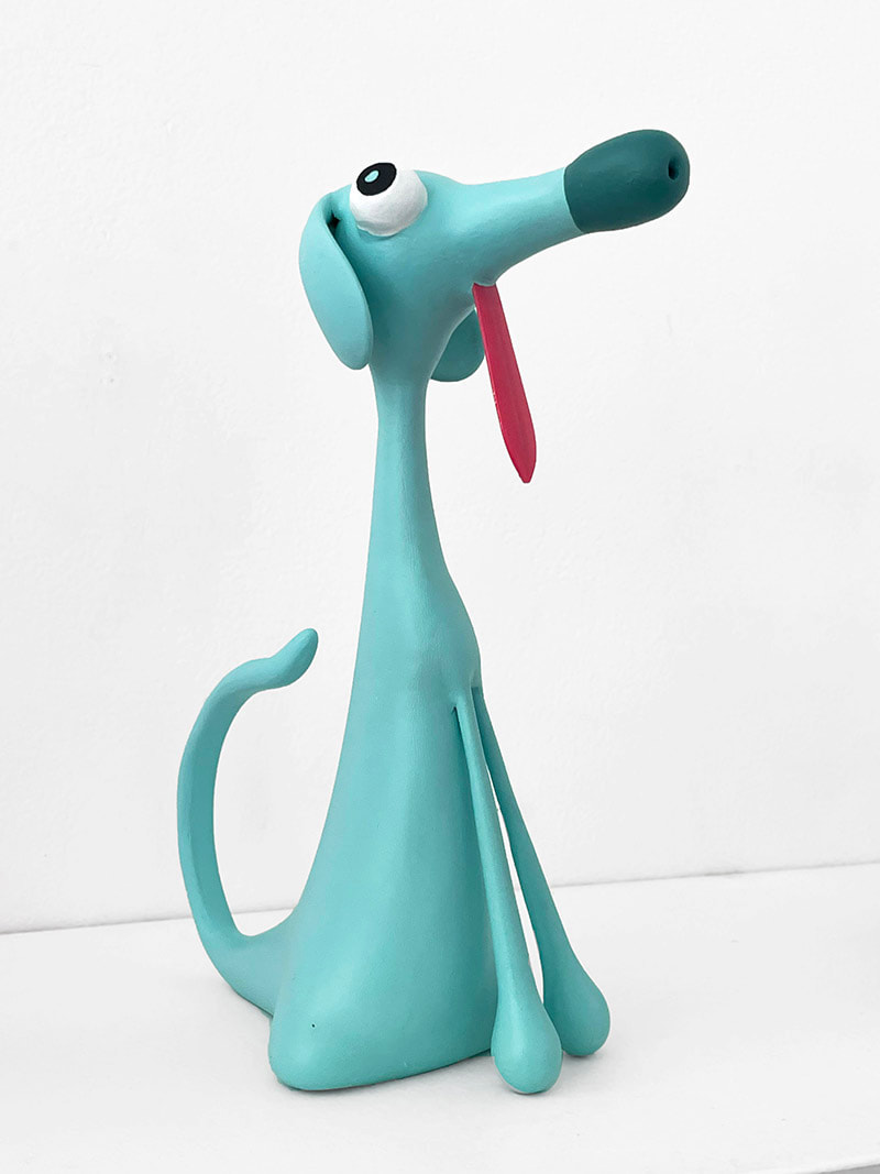 cartoonish perky dog sculpture with a long pink tongue hanging out of it's mouth