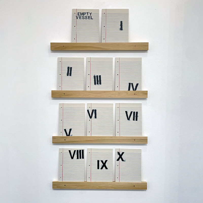 sculpture made of sheets of porcelain that look like sheets on notebook paper with roman numerals drawn on them