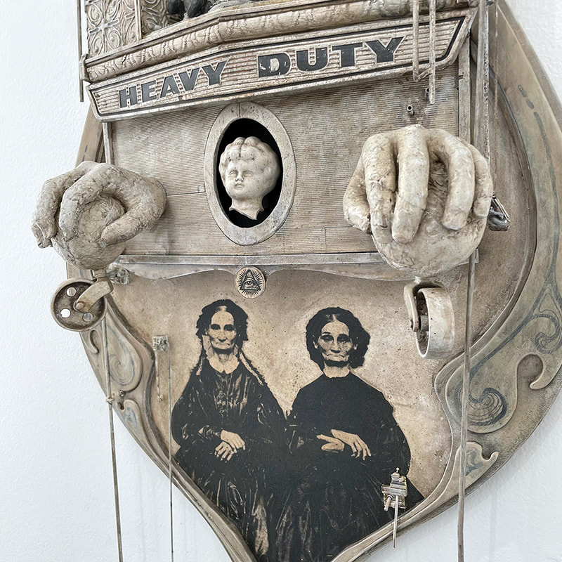 closeup of an art piece with antique portraits of two women