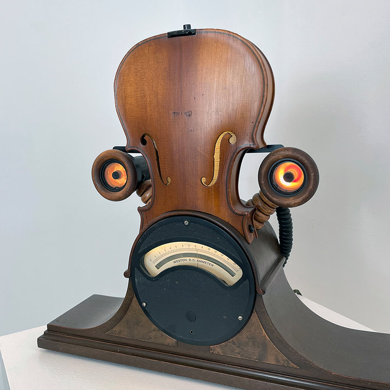 sculpture made of violin, lights and a dial