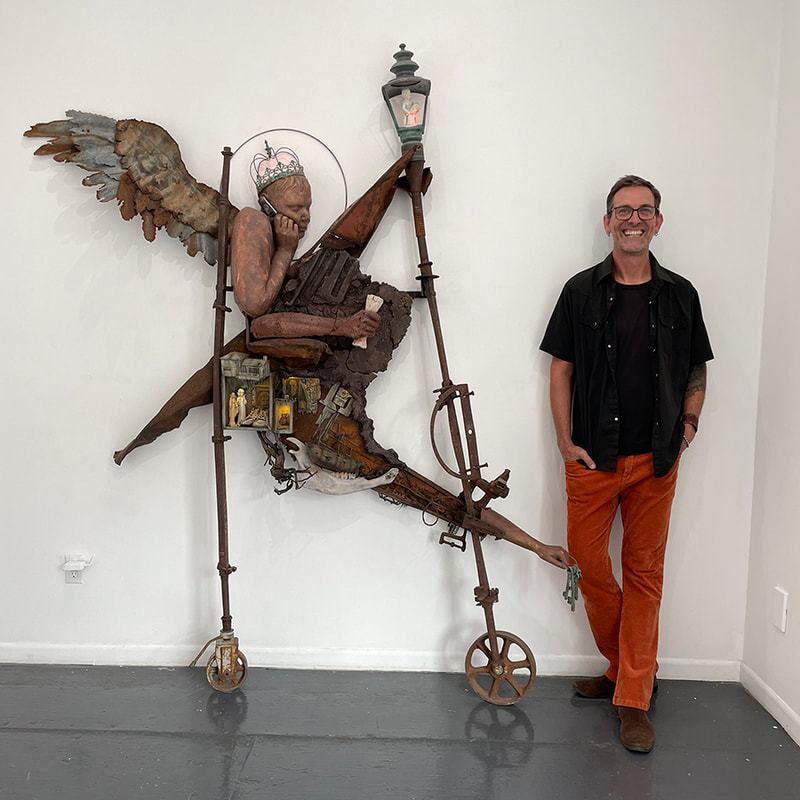 Artist Judson King Smith and a sculpture of a winged person made of many objects