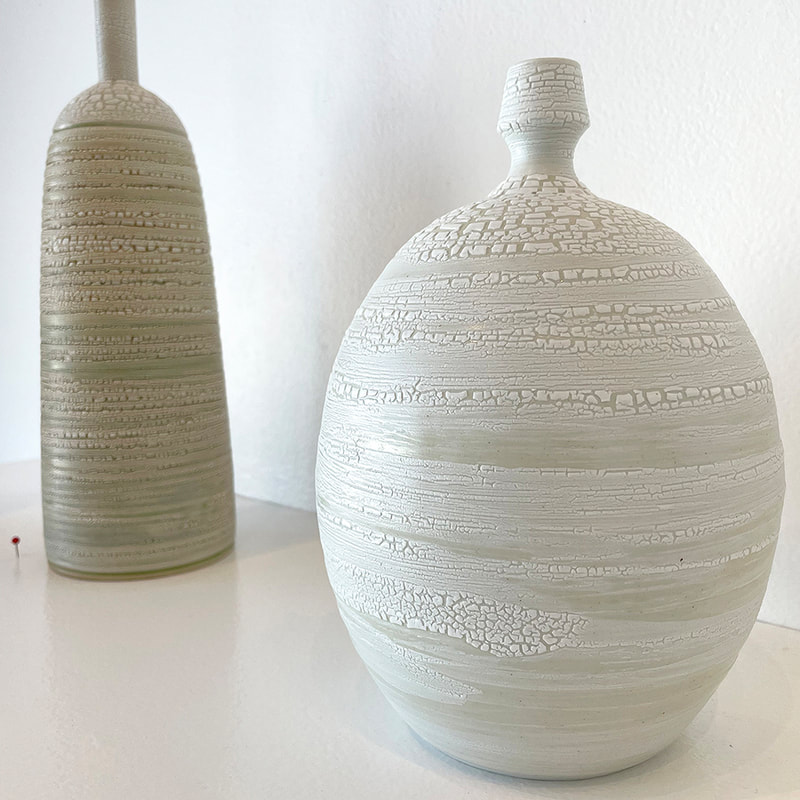 two textured white bottles