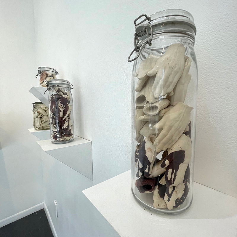 Ceramic hands in a jar