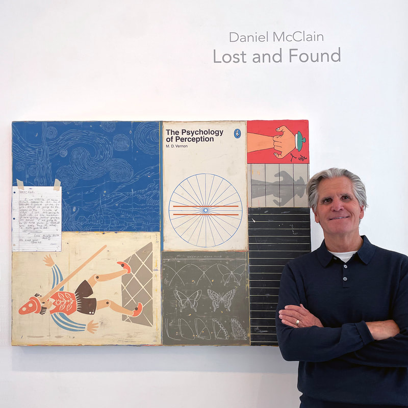 Man in a long sleeved shirt standing near his painting of Pinocchio, a hand written letter, the cover of The Psychology of Perception, a section of a chalkboard and "How to Draw Butterfies"