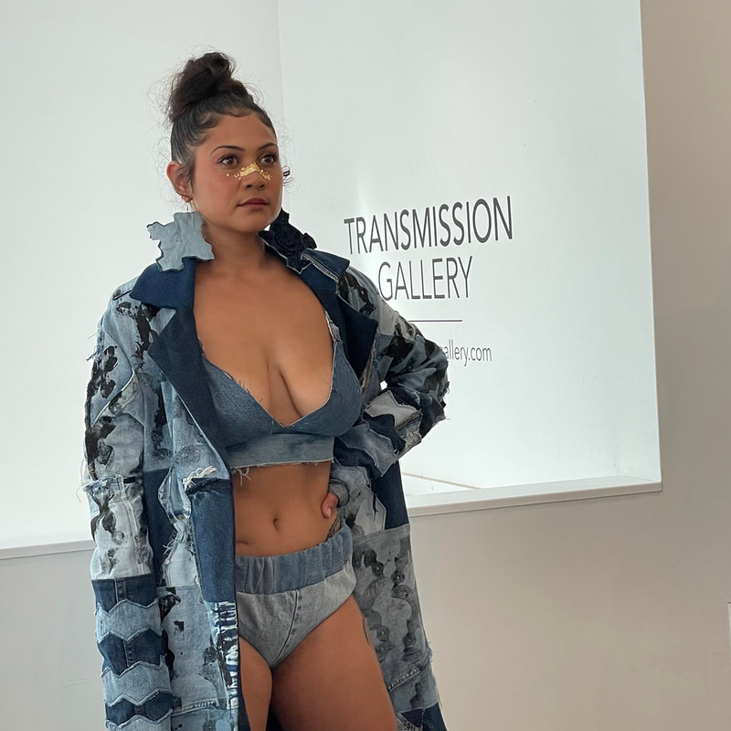 Model wearing  a bikini and trench coat made from denim