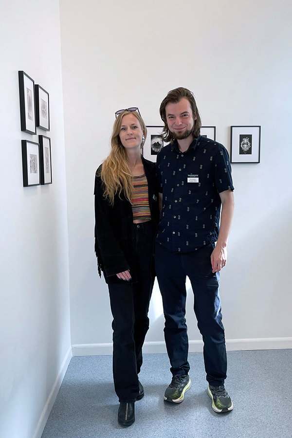 two artists at an art gallery