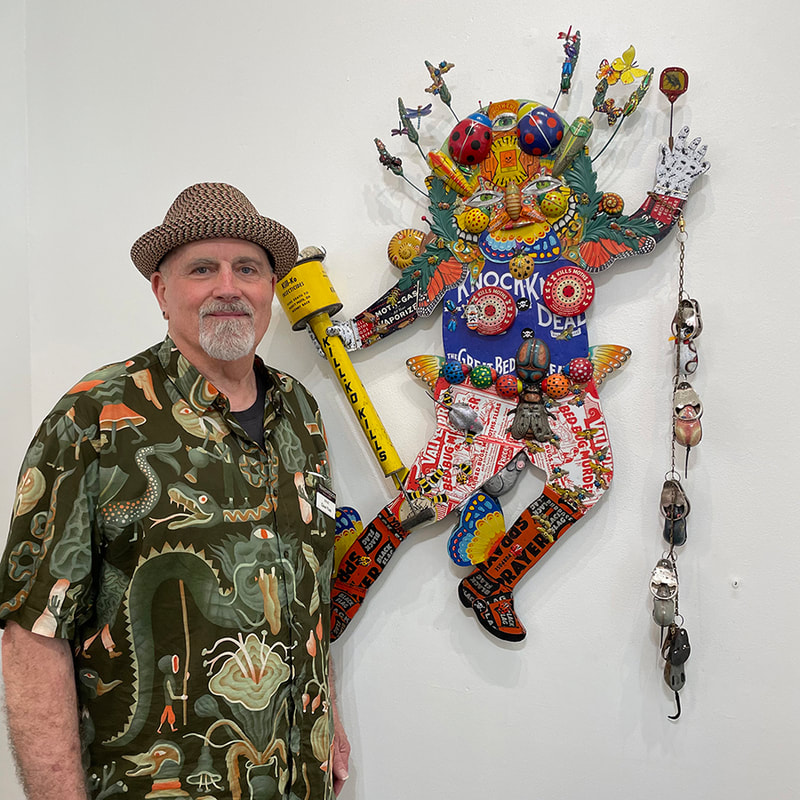 Man and sculpture of a figure covered in bugs 