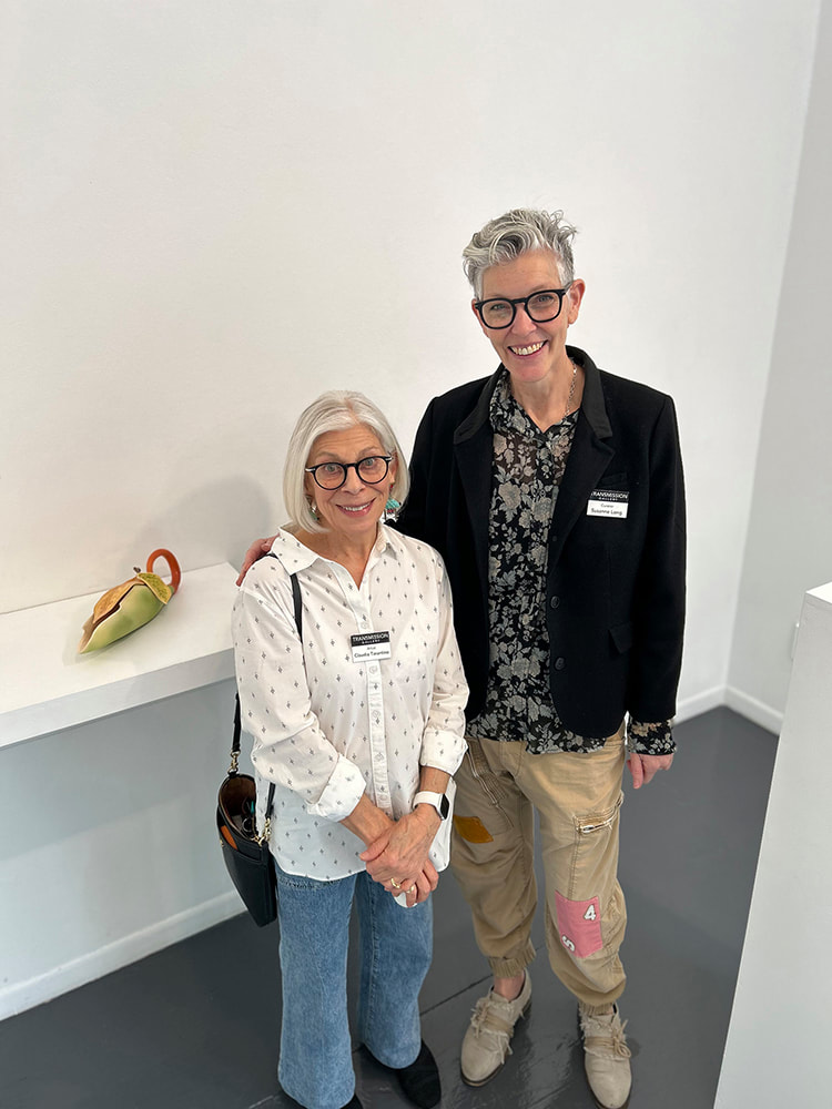 short woman in white blouse with tall woman in black jacket