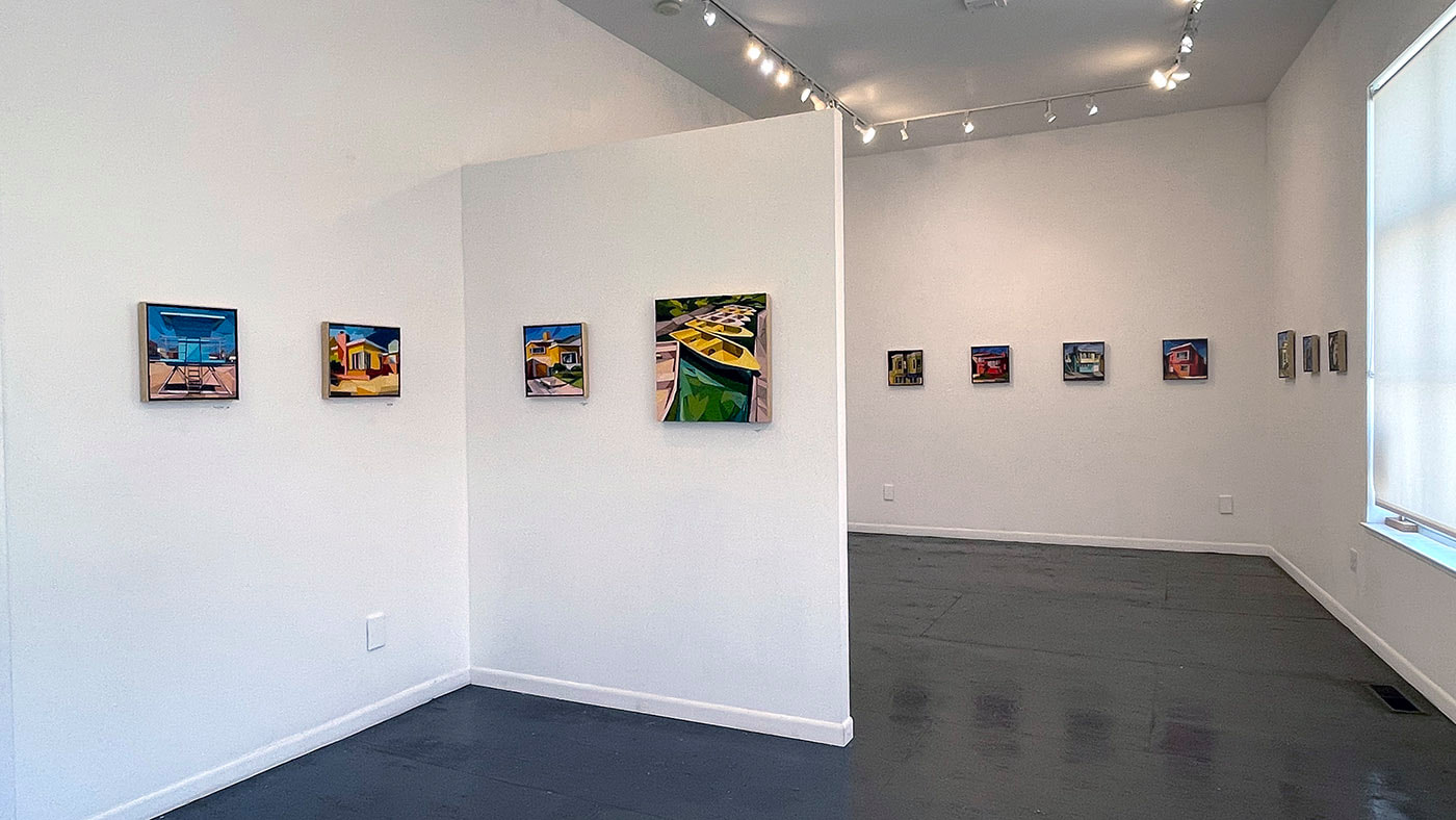 art gallery interior with row of colorful collage artworks depicting  small urban neighborhood homes, one depicts rowboats.  