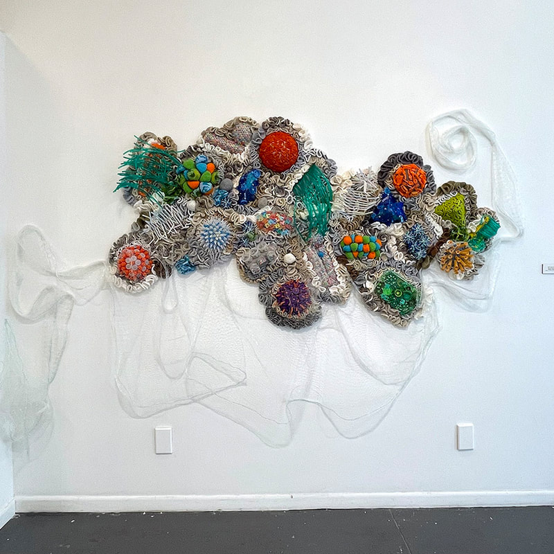 artwork made of plastic pieces mimicking a coral reef