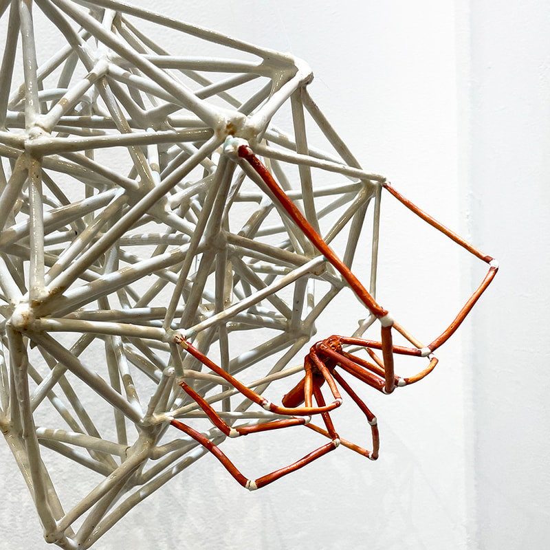 detail of ceramic spider and web ball