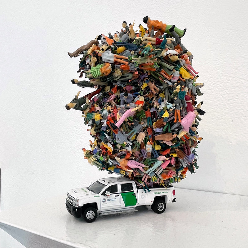 toy pickup truck with pile of toy people teetering over it