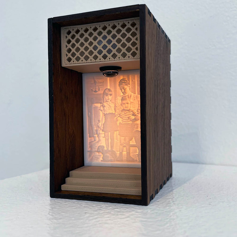 lighted box with image of mother and two children