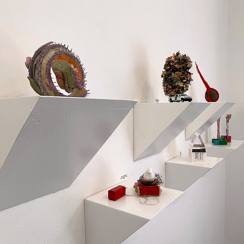 six small sculptures in an art gallery